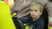The Boy Turns The Steering Wheel In Racing Simulator