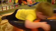  Little Boy Spinning On A Swing At An Amusement Park