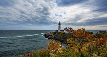 Portland Lighthouse With Fall Foliage And Clouds