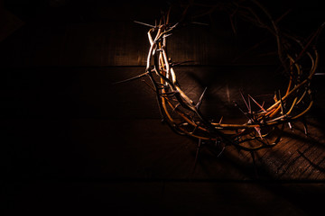 An authentic crown of thorns on a wooden background. Easter Theme