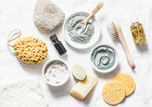 Spa Accessories - Nut Scrub, Sponge, Facial Brush, Natural Soap, Clay Face Mask, Pumice Stone, Essential Oil On A Light Background, Top View. Healthy Lifestyle Concept. Beauty, Skin Care. Flat Lay
