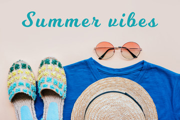 Wall Mural - Summer fashion flatlay with gradient round sunglasses, straw hat, espadrille sandals and t-shirt on the beige background. Perfect beach set for holidays on the sea. Marina style. Summer vibes.