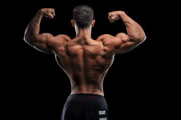 Young handsome sportsman bodybuilder weightlifter with an ideal body, after coaching poses in front of the camera, abdominal muscles, biceps triceps. In sportswear.