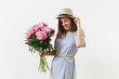 © ViDi Studio - Young tender woman in blue dress, hat holding bouquet of beautiful pink peonies flowers isolated on white background. St. Valentine's Day, International Women's Day holiday concept. Advertising area.