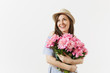 © ViDi Studio - Young tender woman in blue dress, hat holding bouquet of beautiful pink peonies flowers isolated on white background. St. Valentine's Day, International Women's Day holiday concept. Advertising area.