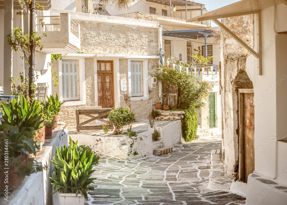 Narrow street with white houses, Greece - obrazy, fototapety, plakaty 