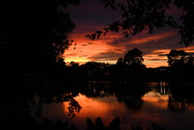 A Radiant Sunset Is Cast Over A Beautiful Lake Revealing The Most Beautiful Colors Of The Day Time Right Before Night.