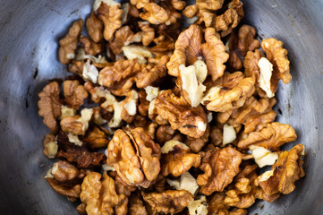 Walnuts kernels with color background, Whole walnut in a metal plate. Walnuts. Walnuts an market. Background of walnuts. Healthy.