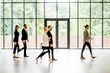 © rh2010 - Business people walking at the modern hall on the window background indoors. long exposure image technic with motion blurred people