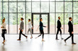 © rh2010 - Business people walking at the modern hall on the window background indoors. long exposure image technic with motion blurred people
