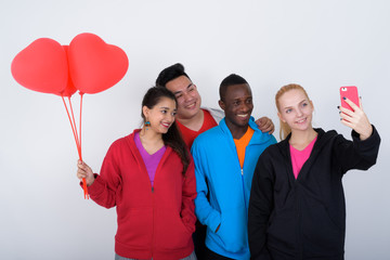 Wall Mural - Studio shot of happy diverse group of multi ethnic friends smili