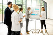 © rh2010 - A group of business people standing together during the conference with flip chart at the modern office