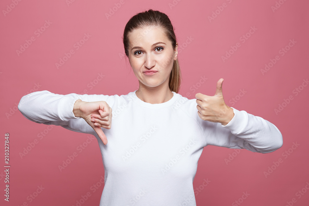 Good or bad? Suspicious woman looks doubtfully, curves lips, being ...