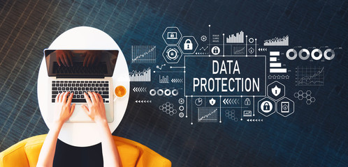 Wall Mural - Data protection with person using a laptop on a white table