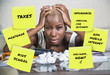 © TheVisualsYouNeed - desperate and frustrated black afro american woman domestic accounting worried about money paying taxes calculating expenses and payments