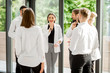 © rh2010 - Business people strictly dressed in white having a conversation standing together at the office hall