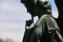 A Tombstone Sculpture Of An A Thoughtful Angel 