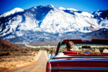 Man Driving A Classic Car Through The American West