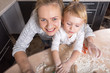 © AnastazjaSoroka - Happy family! A tiny daughter spends time with her mother in the kitchen to bake cookies. Mother's Day.