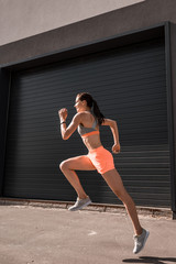 Wall Mural - young attractive sportswoman running in sportswear