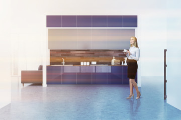 White kitchen interior, blue countertops, woman