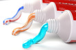 Tubes of toothpaste in different colors and differnt types of toothpaste