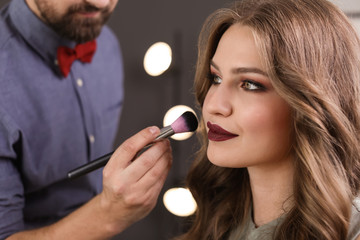 Poster - Professional makeup artist working with client in dressing room