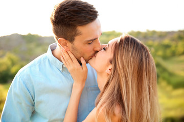 Canvas Print - Cute young couple in love posing outdoors on sunny day