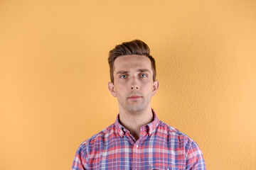 Wall Mural - Handsome young man on color background