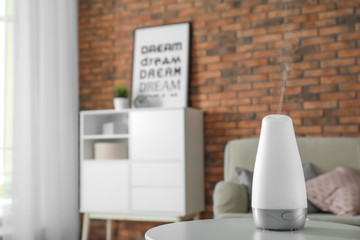 Sticker - Aroma oil diffuser on table at home. Air freshener