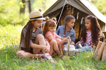 Wall Mural - little children near tent outdoors. summer camp