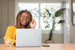 © Krakenimages.com - African american woman with laptop surprised with an idea or question pointing finger with happy face, number one