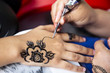 Applying henna tattoo