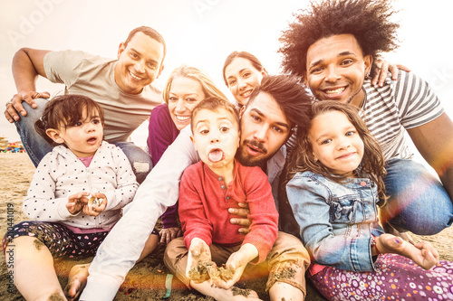 Happy Multiracial Families Taking Selfie At Beach Making Funny