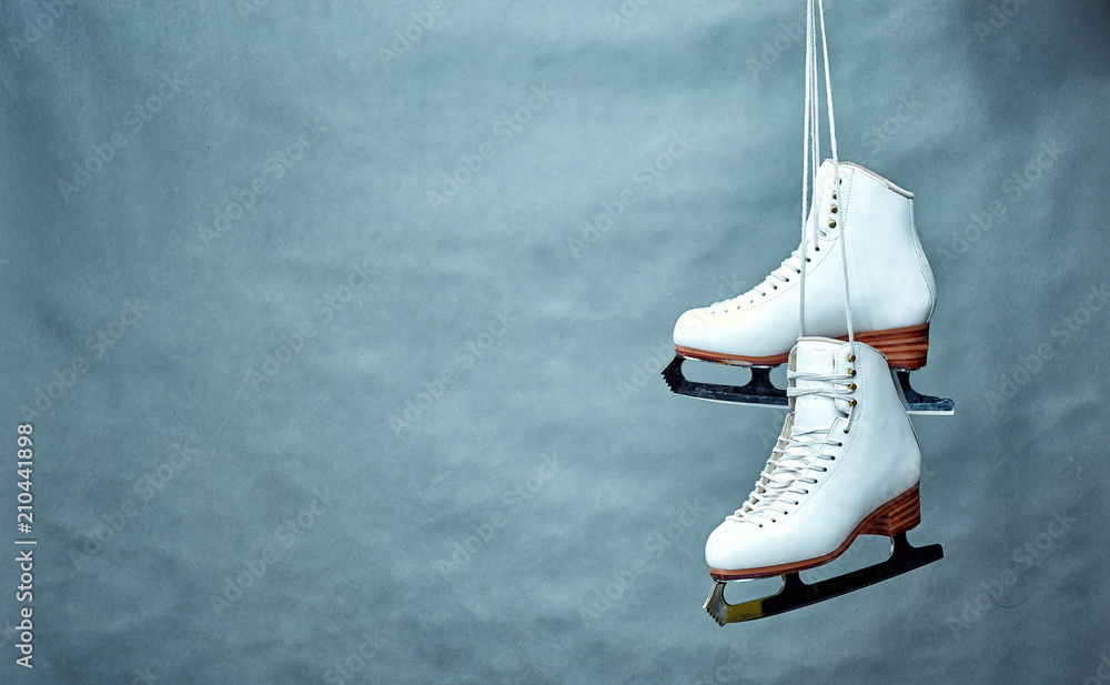 Women's skates with laces on a gray background. - obrazy, fototapety, plakaty 