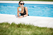 © rh2010 - Portrait of a beautiful woman in black swimsuit relaxing with cocktail at the swimming pool outdoors
