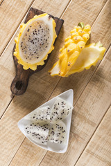 Wall Mural - yellow pitahaya dragon fruit on wooden background