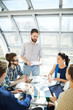 © pressmaster - Group of young employees listening to report of their colleague at working seminar