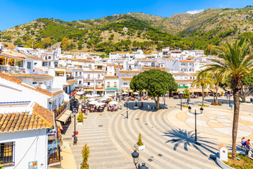 MIJAS VILLAGE, SPAIN - MAY 9, 2018: Main square with houses in picturesque white village of Mijas, Andalusia. Southern Spain is famous for mountain villages with white architecture.