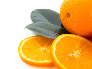 Fresh juicy oranges with slices and green leaves. Isolated on a white background with copyspace for your text.