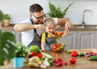 © JenkoAtaman - happy family father with son preparing vegetable salad