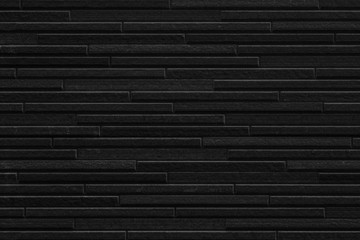 Modern black stone tile wall pattern and seamless background