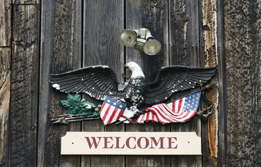 old eagle sculpture hanging on the ancient wood door