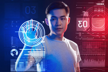security system. calm attentive programmer looking attentively at the screen while using a new secur