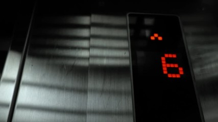 In elevator of modern business center on electronic LCD display. View of the panel with the number and steel silver lining. The monitor shows the number four, five, six, 4, 5, 6.