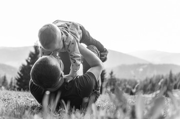 Poster - Laying Father Holding Son in Arms