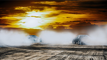 Dramatic car drift battle on speed track circuit at sunset.Motor sport concept.