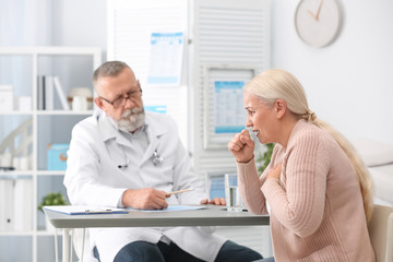 Poster - Coughing mature woman visiting doctor at clinic