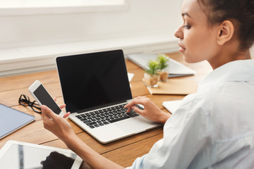 young woman using laptop with blank screen