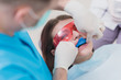 doctor orthodontist performs a procedure for cleaning teeth